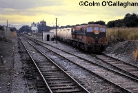 141 Class loco No.152 heads north out of Cabra with bulk cement wagons bound for North Wall yard on the east side of the city, July 1987. The disconnected siding on the left was very rarely used. ©Colm O&#39;Callaghan