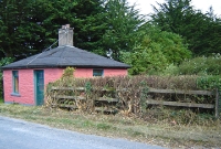 This is the level crossing east of Cappagh, located nearer to the town land the station served. The small stone built crossing keepers house survives here, the fence marks the former trackbed.