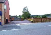 The site of the level crossing at the west end of Cappoquin Station on the N72 road, which runs through the small town. This view is looking towards Mallow.