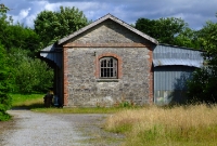 The stone built goods shed at the east end of Cappoquin Station, complete with wooden canopy. The shed remained busy until the end of the line in 1967.