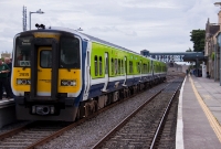 An Irish Railway Record Society special, headed by 2800 Class railcar No.2818, is seen at the down platform at Carlow Station awaiting the road north to Dublin. The IRRS&#39;s blue and white headboard is visible in the driver&#39;s cab.