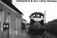 121 Class locomotive No.B131 pauses at Carrolls Cross with a Waterford to Mallow service in the late 1960s. The station only had a single platform, along with a corrugated iron shelter. ©Waterford &#38; Suir Valley Railway