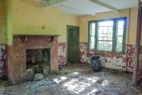 The interior of one of the derelict houses built to house railway staff of the Castlecomer branch, at Castlecomer Junction. The walls and windows are painted in CIE&#39;s 1950s cream and green livery.
