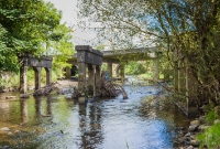 Another view of the 1920s era concrete bridge supports at the River Dinin south of Dysart crossing. Behind them is the modern N78 road bridge. The bridges were dismantled after closure in 1963.