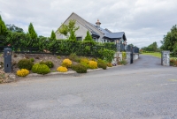 The first level crossing outside Castlecomer on the line towards Kilkenny was at Dysart, located alongside the N78 road. The standard carring keepers house has been substantially rebuilt. On the left is one of the standard GSR/CIE concere gate posts.