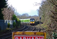 A sign warns of railcar No.29426, seen appearing around the bend at the west end of Castleknock Station on a Maynooth to Dublin Pearse service.