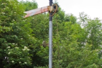 The &#39;Down&#39; distant semaphore signal protecting the approach to the level crossing at Castletown Station. The signal, a CIE type, was installed at this location nearer to the crossing when the station ceased to be blockpost in May 1987.