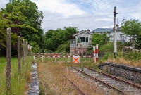 This is the level crossing located at the eastern end of Castletown Station. This view is looking towards Mullingar. Beside the crossing is the disused Midland Great Western signal cabin. On the right is the post of former a signal, removed in 1987 when the station ceased to be a blockpost.