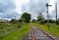 The view looking towards Moate and Athlone, from Killians level crossing, located at the western end of Castletown. The signal is positioned on the trackbed of the former &#39;Down&#39; line of the former double track, removed in the early 1930s, although the section here was retained a long siding until 1987.