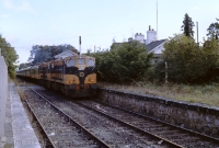 Back in September 1989, when the Mullingar-Athlone line was still in occasional use for main line trains, 181/141 Class locos Nos.186+177 head through Castletown with a Knock special bound for Claremorris. Although the station had ceased to be a crossing place, the disconnected loop remained in situ on the &#39;Up&#39; side, clearly visible in this shot. ©Colm O&#39;Callaghan