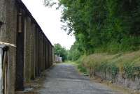 A view of the Great Northern trackbed at the north end of Cavan, looking towards Clones. The structure on the left is the much enlarged cattle market. The GNR&#39;s &#39;Cavan North&#39; signal cabin was once sited to the right beyond the stone and earth wall.