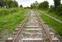 A view looking towards Sligo from the northern extremity of Charlestown Station, showing the condition of the disused line. New mile posts, such as that visible on the left, have been added to the lineside during the vegetation clearance.