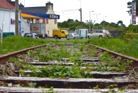 This is the northern approach to Charlestown Station which is visible in the distance. A garage now occupies part of the disused line here.