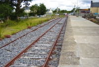 On the single platform at Charlestown Station, looking north to Sligo, showing the through line and loop siding. The goods siding complete with timber buffer stop which once served the small goods shed and yard is visible on the right.