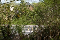 A view looking across the former railway trackbed at Clonakilty Jct from what was the overbridge at the north end of the station. Motorists now speed by unaware of the busy railway activity that once occured here.