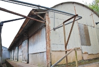 This is the large goods shed at Clonakilty, now used by an adjacent industry which occupies part of the station area. The corrugated iron structure retains its canopy, wooden doors and platform.