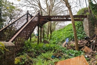 This disused Victorian footbridge which spanned the former line once gave access to the County Home Hospital outside Clonakilty town. Originally the line ran in a cutting here, which has partially been filled in.