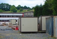 The only major railway structure left at Clones is the concrete built roundhouse (locomotive shed) dating from the late 1900s, an uncommon feature on Irish railways. The building glimpsed here is now used for storage.
