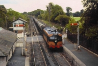 A scene at the east end of Clonsilla Station sees the signalman having given the single token to the driver of 001 Class loco No.023, heading the Dublin to Sligo oil train on 26th Sept 1990. ©Colm O&#39;Callaghan