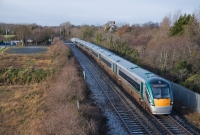 22000 Class railcar No.22242 leads a 6-car set from Sligo to Dublin, seen having just passed the automatic level crossing at Porterstown, east of Clonsilla.