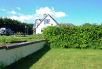 Part of the single platform at the south end of Colbinstown Station survives. The station building was sited where the new house is located. This view is looking north towards Sallins.