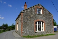 The restored stone built goods shed, located at the north end of Colbinstown Station, as viewed from the approach road.