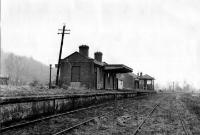 The single platform station at Colbinstown, looking north towards Sallins in the late 1950s, showing the single storey concrete station building complete with canopy, and the signal cabin and goods shed