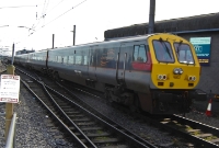 A morning Belfast to Dublin &#39;Enterprise&#39; arrives into Connolly Station from the north, headed by driving van trailer No.9002, which had recently received a full front end yellow warning panel to aid visibility.