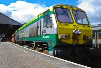 Silver and green liveried 201 Class No.222 stands in the sunshine at the &#39;Enterprise&#39; platform at Connolly having brought in a GAA special formed of Mk3 pushpull stock.
