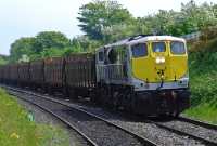 A clean 071 Class loco No.073 has climbed the gradient from Castleknock to Coolmine with its empty timber train bound for Sligo. 073 was built by General Motors in 1976 and is seen here shortly after it had been repainted into the silver &#38; black livery.