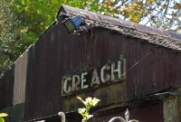 An original wooden name board, located at the northern end of the station building at Creagh.