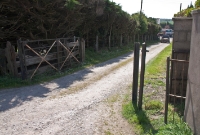 The Cork Bandon &#38; South Coast Railway style gate and posts remain at the entrance to the former Crossbarry Station, adjacent to the R589 road. Although it closed as a junction for the Kinsale branch in September 1931, the station remained in use until March 1961.