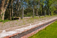 On the former up platform are the remains of the one time wooden waiting shelter, the concrete base of which is all that is left today.