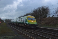 A Mk4 driving trailer leads an &#39;up express from Cork past the platforms at the Curragh. The platforms here have been disused for some years now.