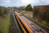 A view from the road overbridge at the Curragh, showing the up &#38; down main line platforms, with a southbound 201 hauled express passing.