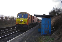 No.205 heads through the Curragh platforms with an afternoon service from Galway to Dublin, seen passing the spartan style waiting shelter on the up platform.