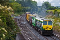 201 Class loco.No.220 passes the disused station at the Curragh with the Ballina to Dublin IWT liner.