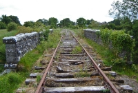 A view looking south towards Claremorris from the Owengarve River near Curry Station. In the foreground the disused state of the line can clearly be seen with the rotting sleepers.