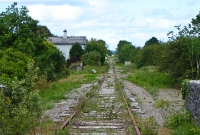 A view from the Owengarve River bridge, looking north towards Sligo showing the disused line, with Curry Station visible. The &#39;Burma Road&#39; as it was known had many gradients.