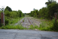 A view looking towards Curry Station from Drumbaun South crossing. The one time goods siding ended in a headshunt on the right beyond the crossing.