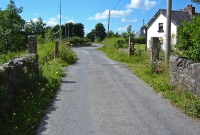 Drumbaun South level crossing from the road side. Today new crossing gates have been installed to prevent access to the disused line.