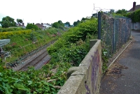 The Dublin to Rosslare line is on the left and the former Dalkey Quarry tram route converges from the right, now the pedestrian laneway. Behind the photographer is Barnhill Rd overbridge and beyond that is the former Atmospheric Railway terminus.