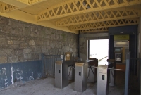 The ticket barriers, and one of the newer ticket machines at Dalkey Station. Note the wooden roof and cast iron cross lattice supports.