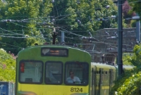 8100 unit, with its missing DART logo, is seen rounding the curve at the south end of Dalkey Station with a stopping service to Howth. The train is ascending the gradient from Dalkey Tunnel which is out of view around the bend.