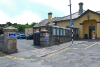 A view from the station forecourt at Dalkey, showing the entrance to the former goods yard, now used for car parking.