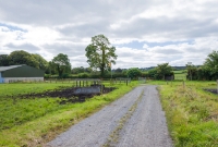 A view looking south towards Castlecomer and Kilkenny from the former Deepark Colliery. The line passed through the gate visible on the right and contined its descent towards the town of Castlecomer.