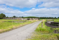 The railway approach to the former colliery at Deerpark. The gravel path follows the route of the tracks serving the coal chutes. The concrete foundations of the mines buildings and pillars of the former elevated coal conveyor are also evident.