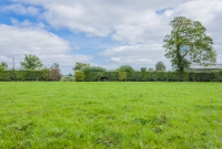 The approach to Deepark Colliery from the railway trackbed, with the roof of the wash baths visible to the right. Originally there was a run around loop located here. The remains of the trackbed here has been ploughed back into the field in recent years.