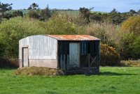 The small wooden constructed goods shed at the former Desert Station, located on the up side of the line. As well as handling local goods traffic, the station also handled produce from the adjacent Desert Woollen Mill, now long since gone.