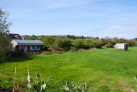 This is the station site at Desert, looking west towards Bantry. The station had one platform, with two goods sidings serving the goods store on the right. The station remained open until closure of the west Cork lines in 1961.